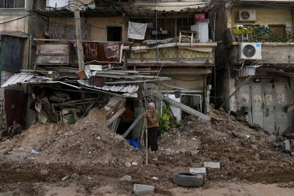 A Palestinian refugee stands in front of his shop damaged during the Israeli operation in Tulkarem, West Bank, on Thursday.