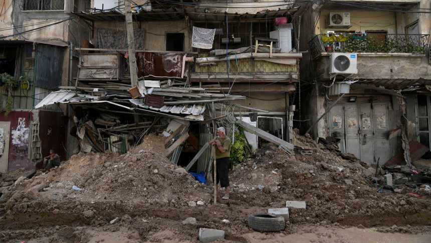 A Palestinian refugee stands in front of his shop damaged during the Israeli operation in Tulkarem, West Bank, on Thursday.