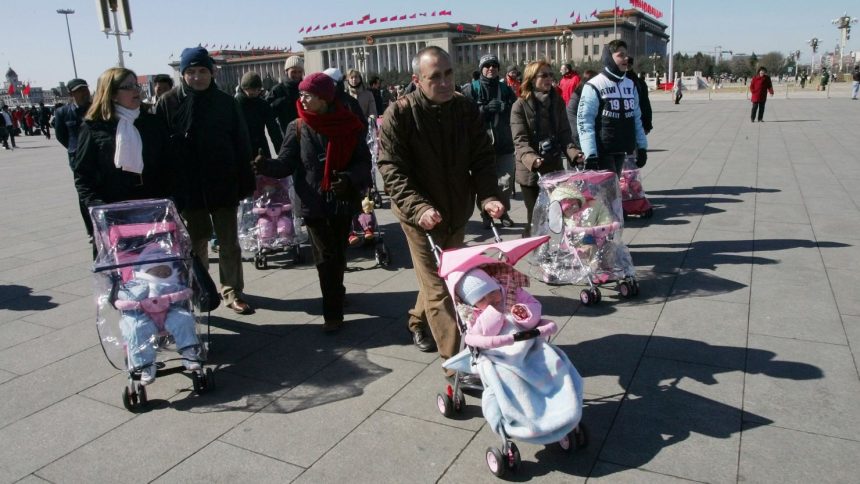 Spanish couples take their newly adopted Chinese children for a walk in Beijing's Tiananmen Square on March 7, 2007.