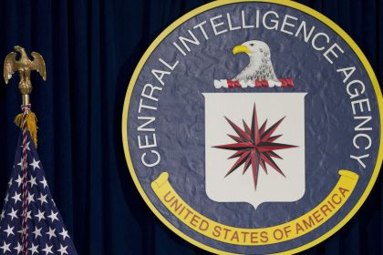 FILE - The seal of the Central Intelligence Agency stands next to a U.S. flag at CIA headquarters in Langley, Va. (AP Photo/Carolyn Kaster, File)