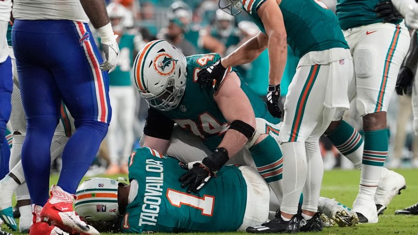 Miami Dolphins quarterback Tua Tagovailoa lies on the field after suffering what his team says was a concussion during the second half in Thursday's game against the Buffalo Bills in Miami Gardens, Florida.