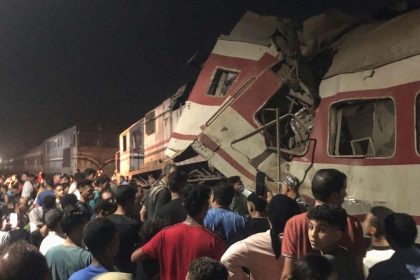 People surround two passenger trains which collided in the Egyptian city of Zagazig on Saturday, Sept. 14, 2024.