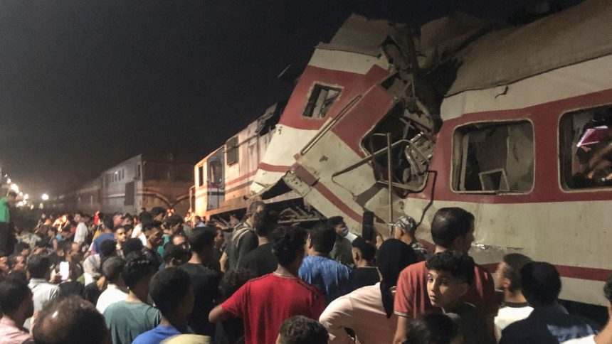 People surround two passenger trains which collided in the Egyptian city of Zagazig on Saturday, Sept. 14, 2024.