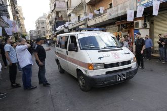 An ambulance drives through a southern suburb of Beirut after explosions were heard.