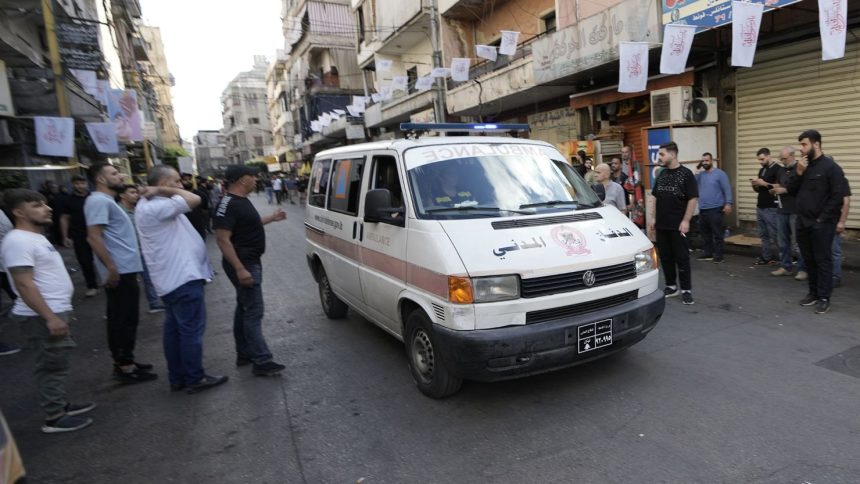 An ambulance drives through a southern suburb of Beirut after explosions were heard.