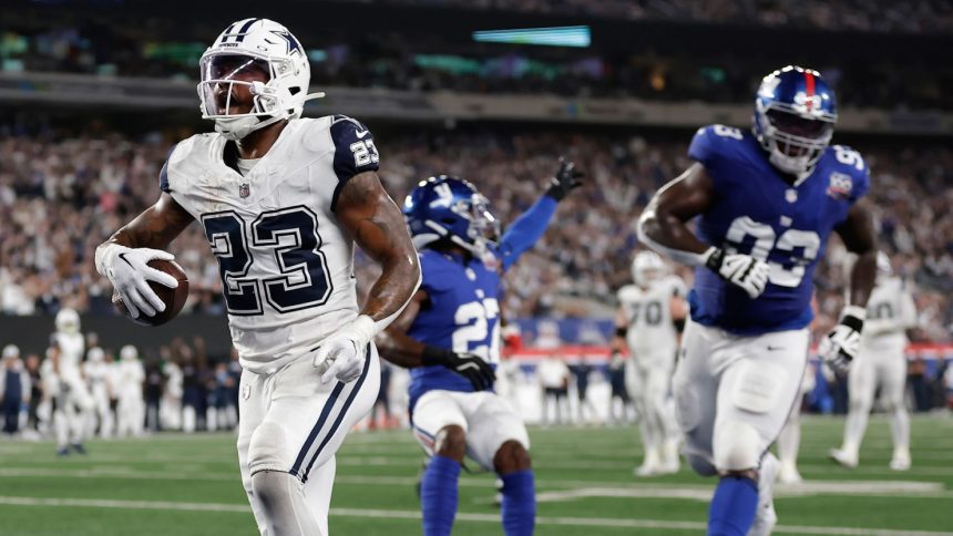 Dallas Cowboys running back Rico Dowdle celebrates scoring a touchdown against the New York Giants.