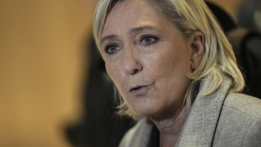 Marine Le Pen speaks to the media as she arrives at the court house in Paris, Monday, September 30, 2024.