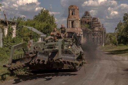 Ukrainian servicemen operate an armored military vehicle on a road near the border with Russia, in the Sumy region of Ukraine, on August 14.