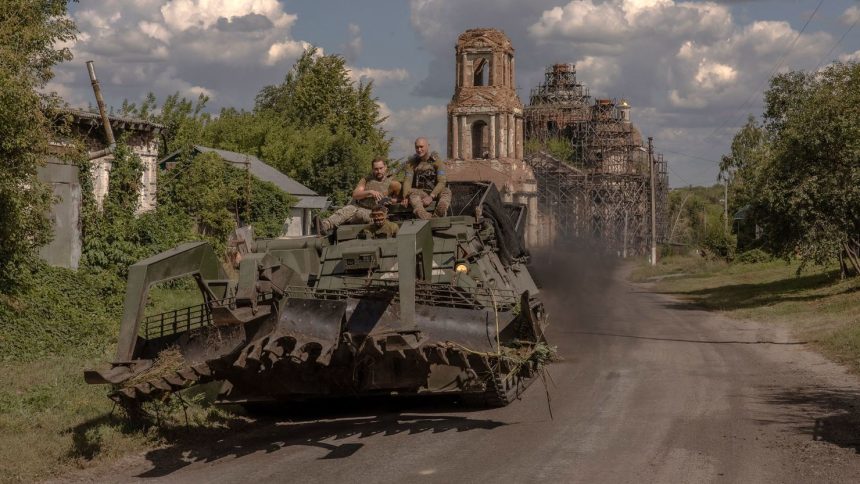 Ukrainian servicemen operate an armored military vehicle on a road near the border with Russia, in the Sumy region of Ukraine, on August 14.