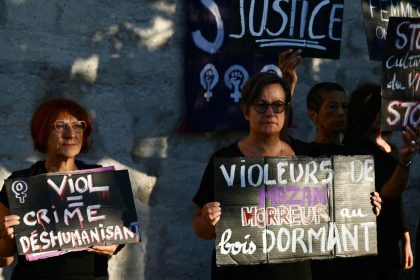 Demonstrators hold placards during a protest outside the courthouse during the trial of a man accused of drugging his wife for nearly ten years and inviting strangers to rape her at their home in Mazan, a small town in the south of France, in Avignon, on September 2, 2024.