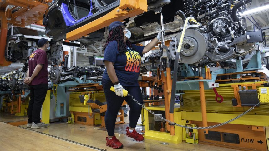 A 2021 Jeep Grand Cherokee L is assembled at the Stellantis Detroit Assembly Complex-Mack in June 2021 in Detroit.