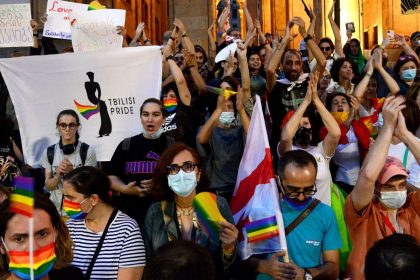 Participants hold rainbow flags at a march in Tbilisi, Georgia, after the annual Pride march was disrupted by anti-LGBTQ protesters, July 6, 2021.