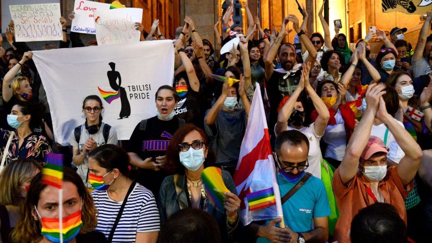 Participants hold rainbow flags at a march in Tbilisi, Georgia, after the annual Pride march was disrupted by anti-LGBTQ protesters, July 6, 2021.