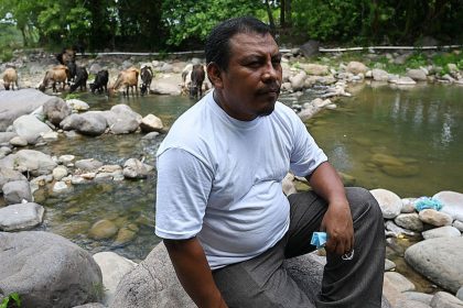 Honduran environmentalist Juan Lopez sits on the banks of the Guapinol river on the outskirts of Tocoa, Colon department, Honduras, on September 28, 2021.