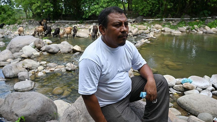 Honduran environmentalist Juan Lopez sits on the banks of the Guapinol river on the outskirts of Tocoa, Colon department, Honduras, on September 28, 2021.