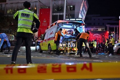 Medical staff attend to a person on a stretcher in the popular nightlife district of Itaewon in Seoul on October 30, 2022, after thousands of people crowded into the neighborhood's narrow streets to celebrate Halloween.