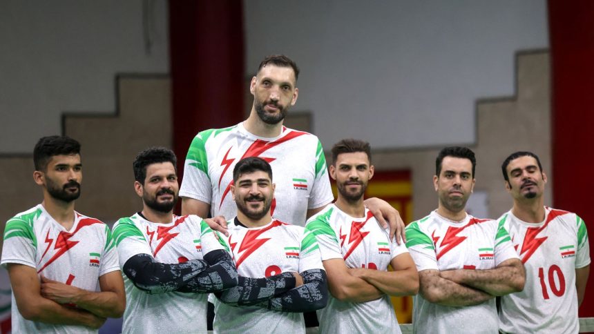 Morteza Mehrzadselakjani (top center) poses for a picture with his Iranian teammates during a training session of the men's sitting volleyball team ahead of the 2024 Paralympics Paris Games.