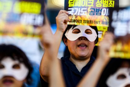 Activists wearing eye masks hold posters reading 'Repeated deepfake sex crimes, the state is an accomplice too' during a protest against deepfake porn in Seoul, South Korea on August 30, 2024.