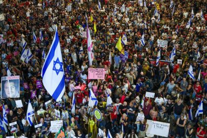 Demonstrators lift placards and flags during a protest calling for the release of Israelis held hostage by Palestinian militants in Gaza since October, in Tel Aviv on August 31, 2024, amid the ongoing conflict in the Gaza Strip between Israel and the Palestinian militant Hamas movement. (Photo by Jack GUEZ / AFP) (Photo by JACK GUEZ/AFP via Getty Images)