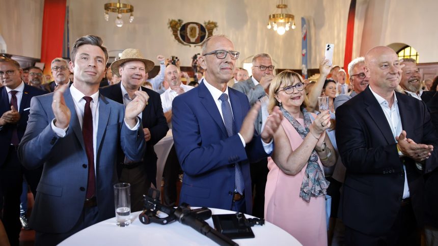 Joerg Urban, center-left, lead candidate of the far-right Alternative for Germany (AfD) in the state of Saxony, and AfD supporters gather for the results in the Saxony state elections on September 1, 2024 in Dresden, Germany.