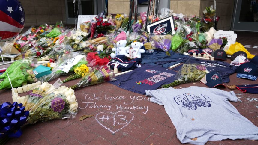 Fans build a memorial outside of Nationwide Arena in honor of the late Columbus Blue Jackets forward Johnny Gaudreau.