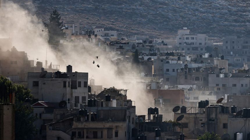 Smoke rises during an Israeli military raid in Jenin in the occupied West Bank on Thursday.