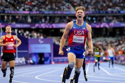 US' Hunter Woodhall celebrates after winning the gold medal during the Men's 400m T62 final event at the Paris 2024 Paralympic Games at the Stade de France in Saint-Denis, outside Paris on September 6, 2024. (Photo by Dimitar DILKOFF / AFP) (Photo by DIMITAR DILKOFF/AFP via Getty Images)