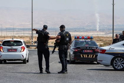 Israeli security forces gather at the scene of the attack near the Allenby Crossing on Sunday.