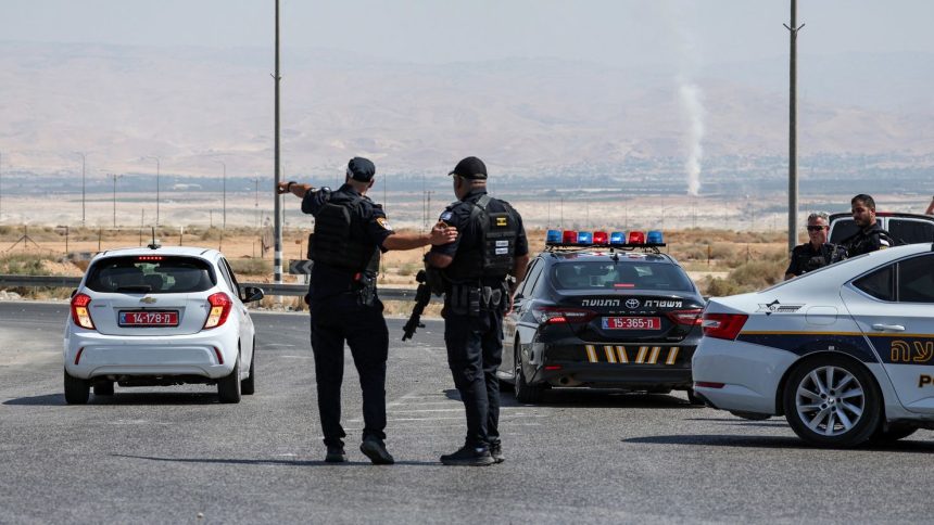 Israeli security forces gather at the scene of the attack near the Allenby Crossing on Sunday.