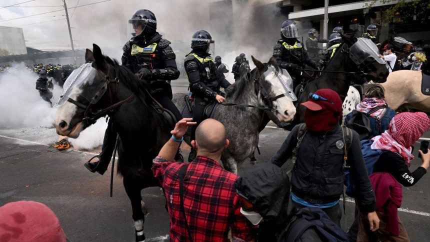 Protesters confront police outside the Land Forces 2024 arms fair in Melbourne on September 11, 2024.