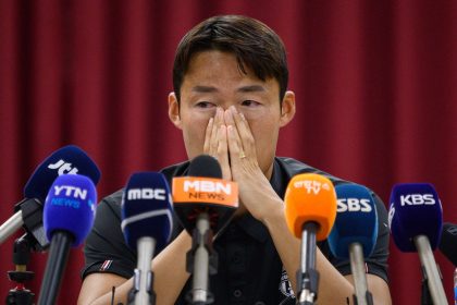 South Korean footballer Son Jun-ho wipes his eyes during a press conference at his K League club Suwon FC in Suwon on September 11, 2024.