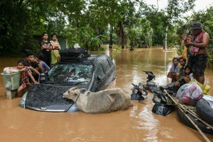 Flood-affected residents wait for a rescue boat to arrive in Taungoo, Myanmar, on September 14, 2024.