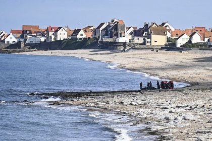 French gendarme use a tractor to pull a damaged migrants' boat after a failed attempt to cross the English Channel that led to the death of 8 people near the beach of Ambleteuse, northern France on September 15, 2024. Eight migrants died when their clandestine boat sank off Ambleteuse (Pas-de-Calais) on September 15, 2024, bringing to over 45 the number of would-be exiles to Britain who died in the Channel in 2024. (Photo by Bernard BARRON / AFP) (Photo by BERNARD BARRON/AFP via Getty Images)