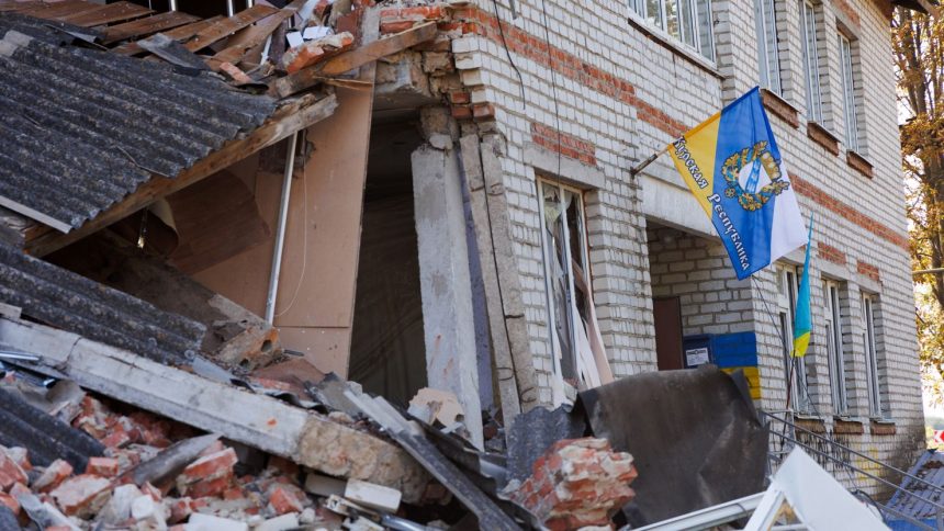 A flag with the coat of arms of the Kursk region is placed on a damaged building on September 10, 2024 in Sudzha, Kursk Region, Russia.