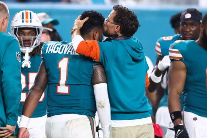 Miami Dolphins head coach Mike McDaniel embraces Tua Tagovailoa as he leaves the field after suffering a concussion against the Buffalo Bills.