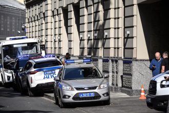 Russian police officers stand guard outside the office building of Russian retailer Wildberries after an attempted raid in central Moscow on September 18.