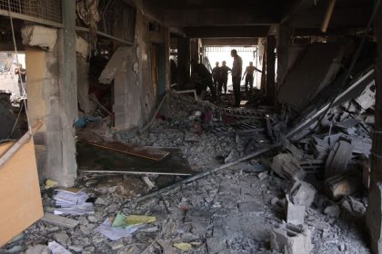 Palestinians inspect the damage at the site of an Israeli strike on a school on Saturday.