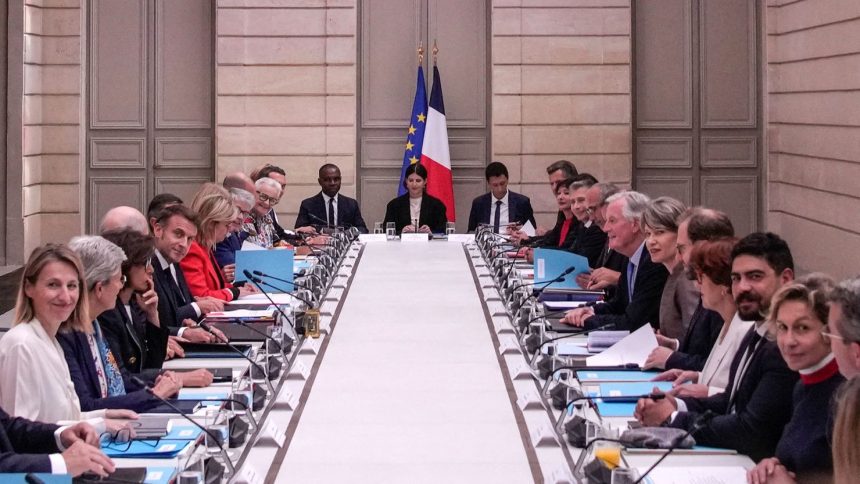 French President Emmanuel Macron (center left) and French Prime Minister Michel Barnier (center right) meet with members of the new government during the weekly cabinet meeting at the Elysee Palace, in Paris, on September 23.