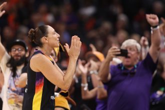 Diana Taurasi reacts to fans cheering as she checks back into the second half against the Seattle Storm at Footprint Center on September 19 in Phoenix, Arizona.