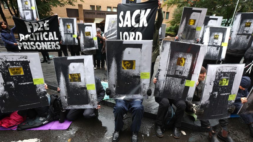 Supporters of Phoebe Plummer and Anna Holland from Just Stop Oil protest in front of Southwark Crown Court on September 27, 2024 in London, England.