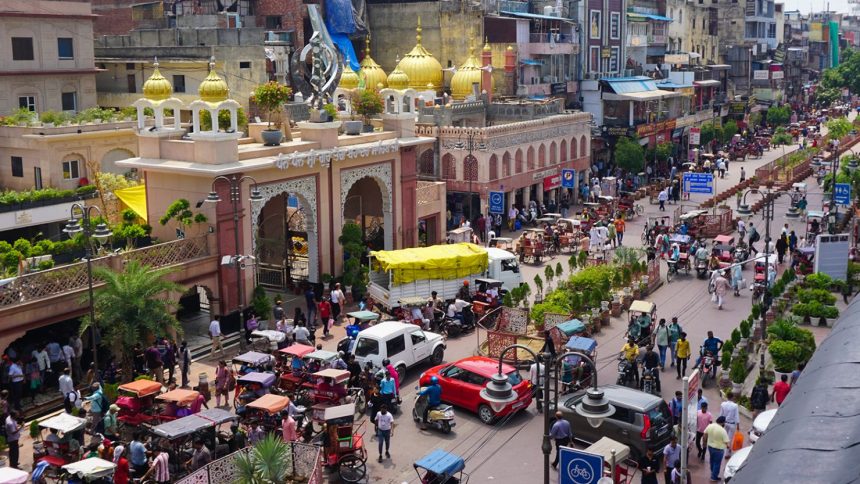 Sis Ganj Gurudwara, a holy place of worship for Sikhs, on the left, followed by the Golden (Sunehri) Mosque pictured in Chandni Chowk, Old Delhi, India.