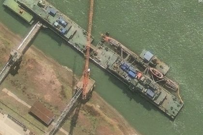 A satellite image from Maxar shows the Zhou class sub sitting at the pier on March 10.