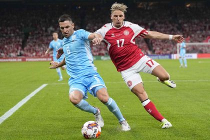 Dante Rossi and Jens Stryger Larsen battle for the ball during a Euro 2024 qualifier between Denmark and San Marino.