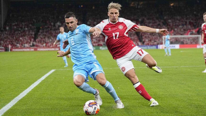 Dante Rossi and Jens Stryger Larsen battle for the ball during a Euro 2024 qualifier between Denmark and San Marino.