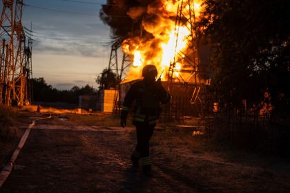 A Ukrainian firefighter talks on the radio while he works to extinguish the fire on the site of an electrical substation that was hit by Russian strike in Dnipropetrovsk region, Ukraine, Monday, Sept. 2, 2024.