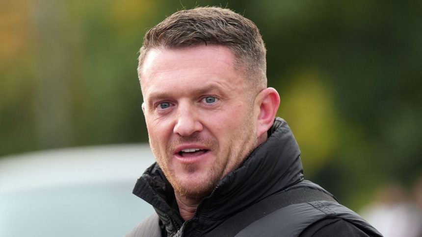 Political activist Tommy Robinson outside Folkestone Police Station on Friday.