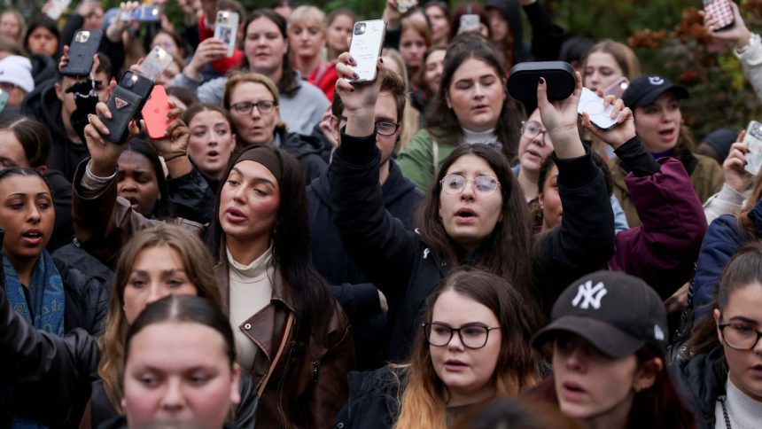 Fans sing at a memorial for former One Direction singer Liam Payne, who was found dead after he fell from a third-floor hotel room balcony in Buenos Aires, in Hyde Park, London, Britain, October 20, 2024.