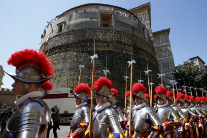 Members of the Vatican's elite Swiss Guard march in front of the Institute for the Works of Religion (IOR).