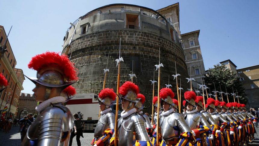 Members of the Vatican's elite Swiss Guard march in front of the Institute for the Works of Religion (IOR).