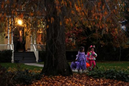 Children go trick-or-treating in the New York suburb of Upper Nyack, New York, on October 31, 2023.